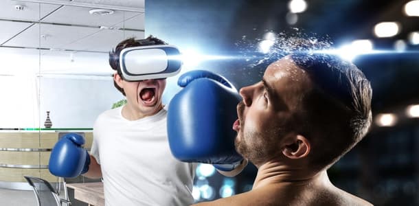 A man with VR goggles throws a punch at a virtual opponent in an office