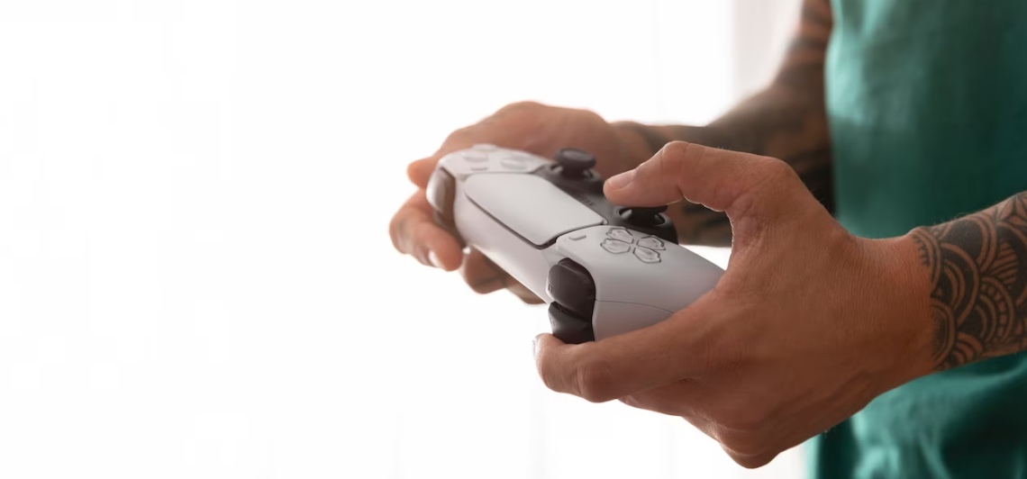 Close-up of hands holding a PS4 controller