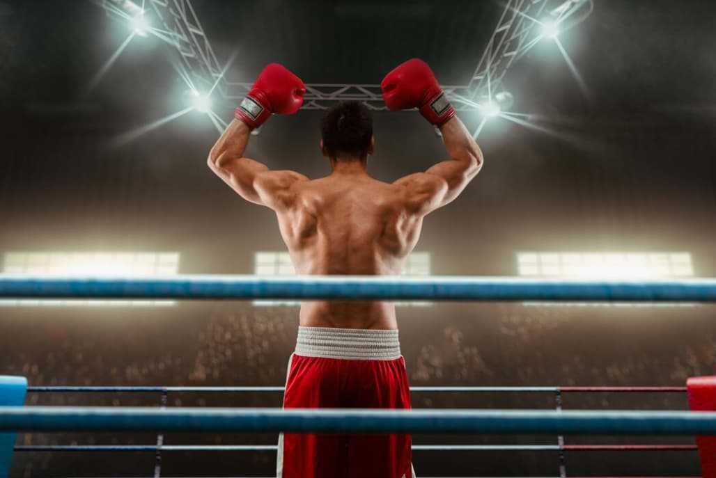 Two boxing gloves clash with a dynamic burst of particles between them