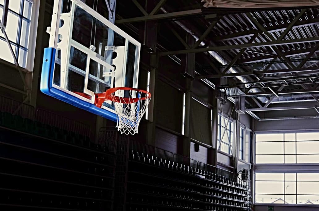 An empty basketball court with a clear view of a hoop